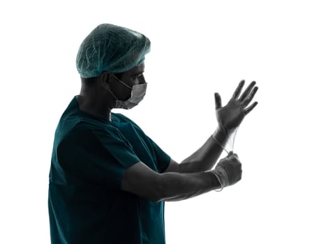 one caucasian doctor surgeon man  latex gloves portrait with face mask medical worker silhouette isolated on white background
