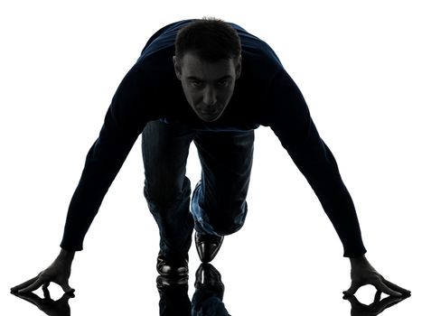 one caucasian man starting blocks full length in silhouette studio isolated on white background