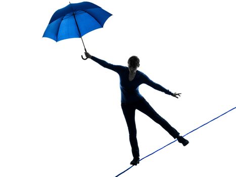 one caucasian woman holding umbrella  in silhouette studio isolated on white background
