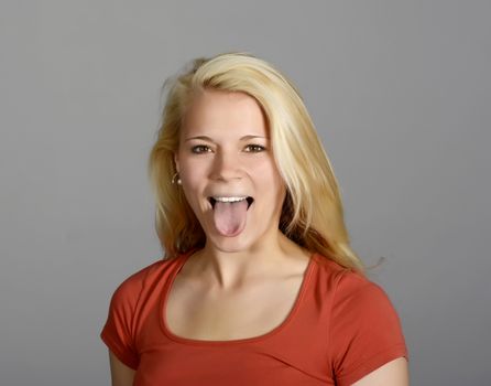 young blond woman showing her tongue