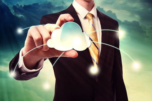 Businessman holding a cloud computing icon over cloudscape background