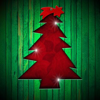 Green wooden wall with a hole in the shape of stylized christmas tree and red velvet background with roses flowers
