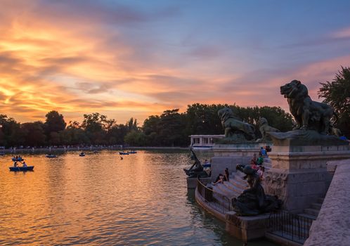 Lion sculptures of Alfonso XII monument in Buen Retiro park lake, Madrid