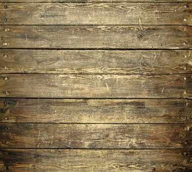 Background texture of old brown worn wooden planks with nails