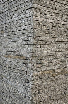 The Background texture of the corner granite stone brick wall