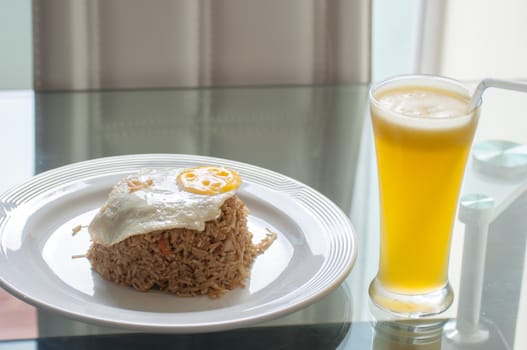 fried egg and spicy fried rice and orange juice