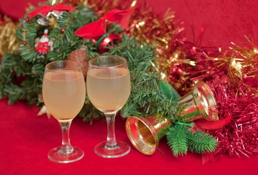 Artificial  christmas tree decorated  and wine on red background .