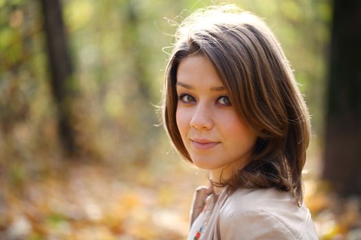 Portrait of beautiful woman in autumn park