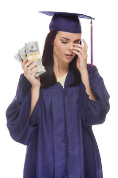 Stressed Female Graduate in Cap and Gown Holding Stacks of Hundred Dollar Bills Isolated on a White Background.