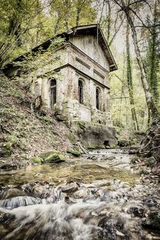 Picture of a old house and creek in a forest in autumn