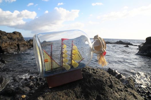 Ancient Spanish Sailing Boat in a Bottle near the Ocean