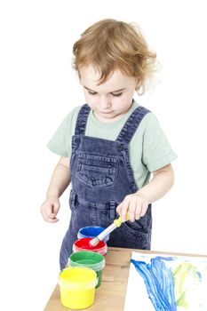 child with brush and paint isolated in white background