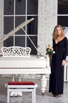 A beautiful young woman playing piano