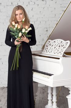 A beautiful young woman playing piano