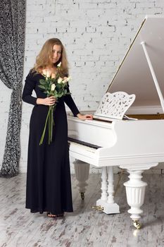 A beautiful young woman playing piano