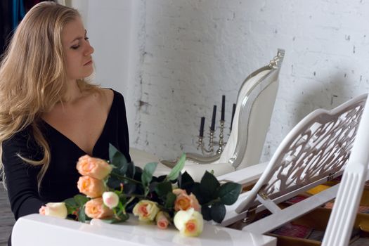 beautiful young woman playing the white piano