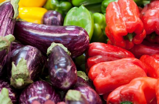 Eggplants and sweet pepper on a shop counter