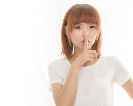 Attractive woman making a keep  quiet habd gesture , isolated on white