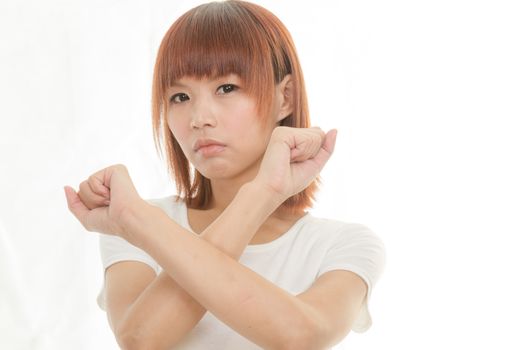 Young Asian woman making stop gesture over white background