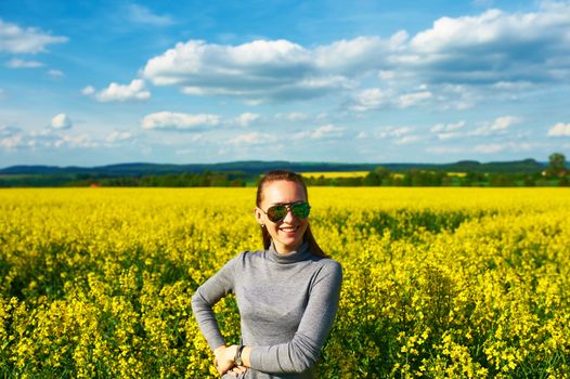 Carefree girl at colza field