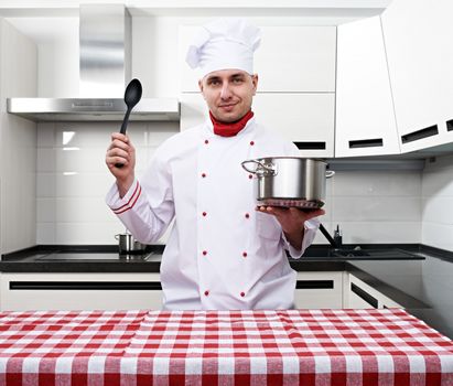 Male chef at kitchen getting ready to cook