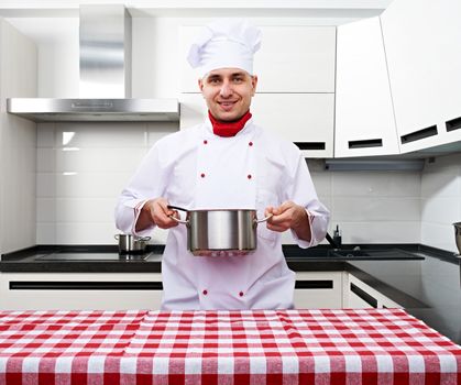 Male chef at kitchen getting ready to cook