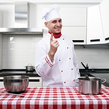 Male chef at kitchen getting ready to cook