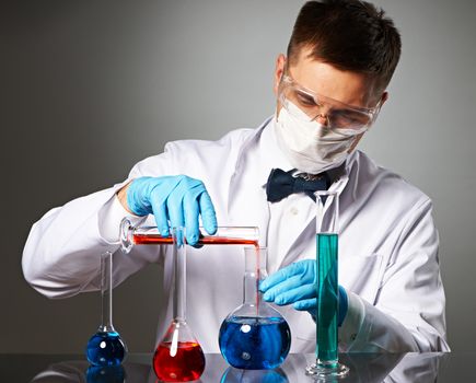 Scientist in protective glasses at laboratory