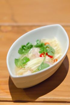 close up spicy green mango salad  in white bowl , asian spicy salad