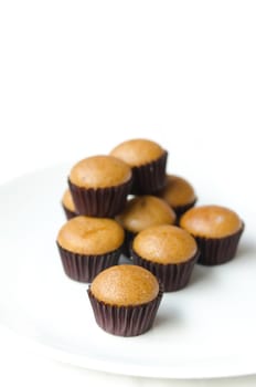 Homemade  brown  muffins  ( made from banana ), Freshly baked on white dish