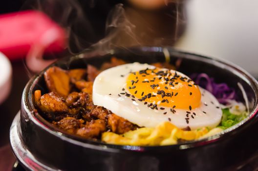 bibimbap in a heated stone bowl ,  korean style cuisine, hot and delicious 