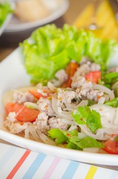 close up spicy  salad with  minced pork ,  vermicelli , chili and fresh vegetable 
