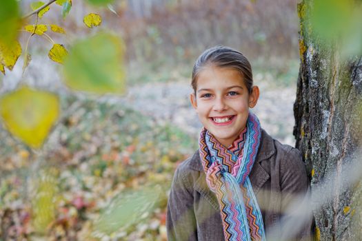 Portrait of beautiful girl walking in a autumn park
