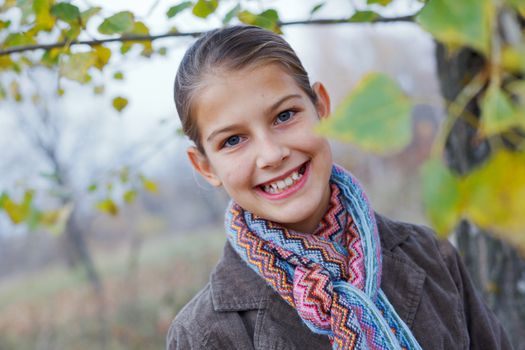 Close-up portrait of beautiful girl walking in a autumn park