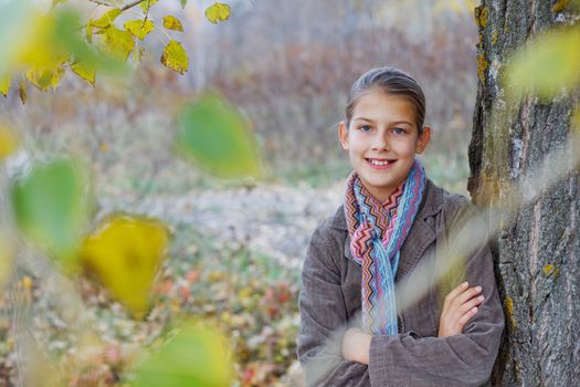 Portrait of beautiful girl walking in a autumn park