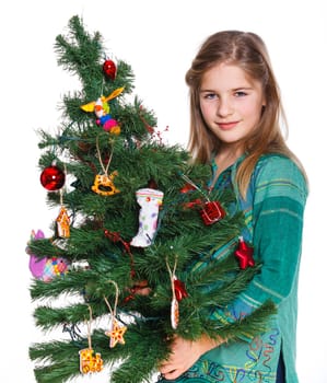 Christmas theme - Beautiful girl decorating christmas tree. Isolated on white backround.