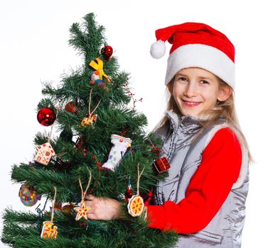 Christmas theme - Beautiful girl decorating christmas tree. Isolated on white backround.