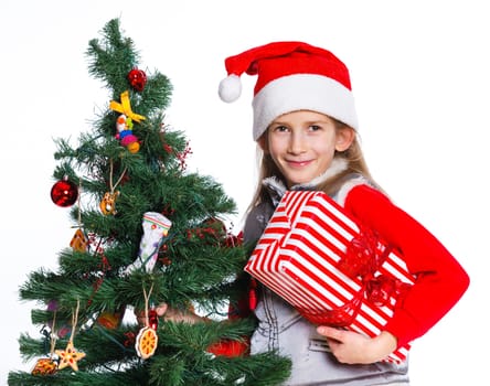 Christmas theme - Beautiful girl decorating christmas tree. Isolated on white backround.