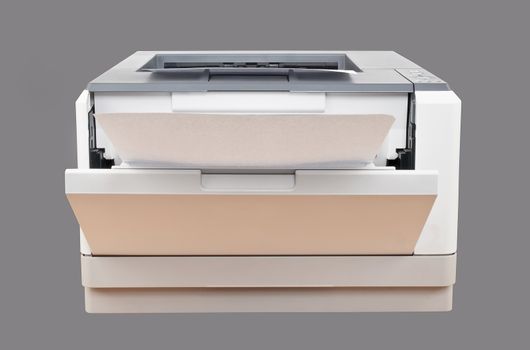 laser printer with paper over gray background