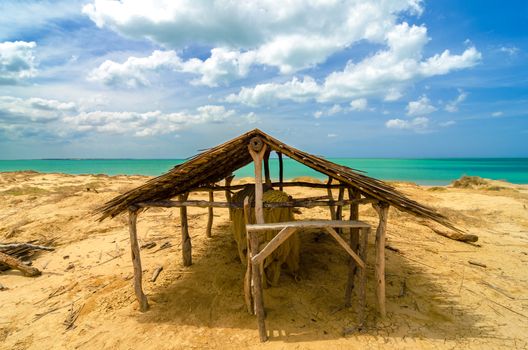 Old wooden hut next to a Caribbean beach in La Guajira, Colombia