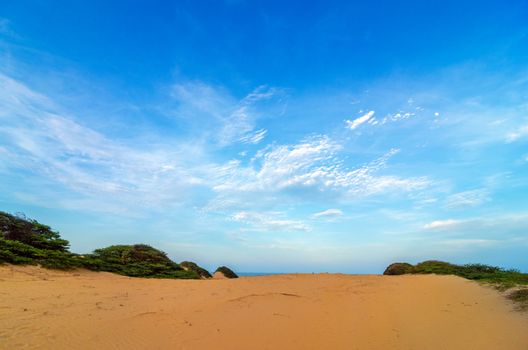 View of a sand dune and deep blue sky