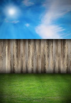 beautiful natural backdrop with wooden fence and green turf