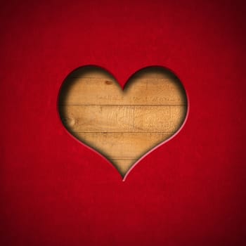 Red Velvet Background with a hole in the shape of heart and old wooden boards