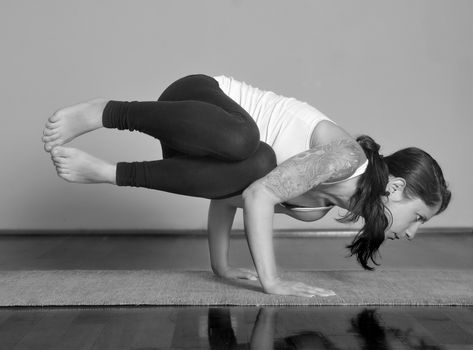 Girl doing Parsva Kakasana yoga pose