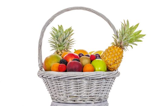 still life of multi-coloured fruits in big basket, on white background, isolated 