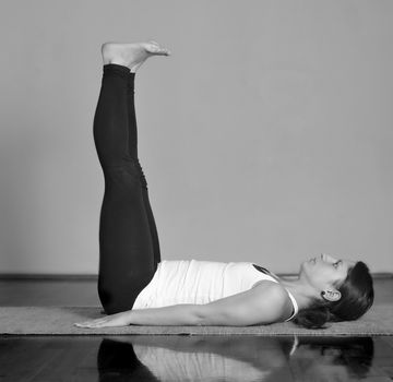 Girl doing Supta Dandasana yoga pose