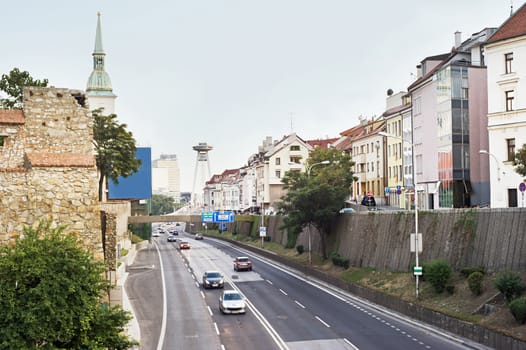 Cars driving on highway in Bratislava, bridge in the background