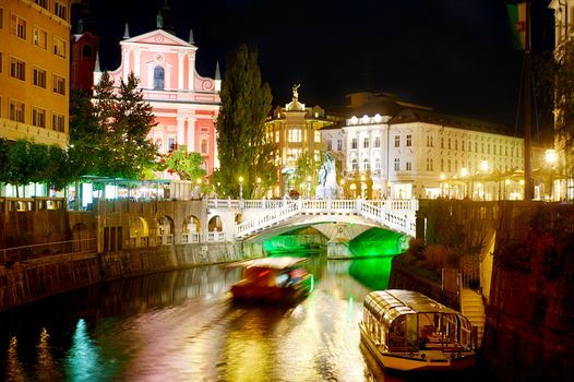 Triple Bridge and Franciscan Church at night. Ljubljana, Slovenia