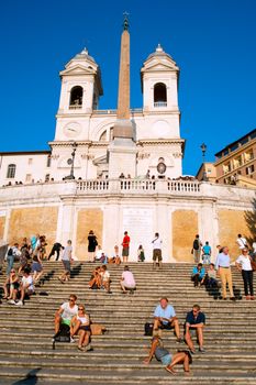 Rome, Italy -  September 27, 2013: Crowd sitting on the Spanish Steps onin Rome, Italy. With 138 steps in total, the Spanish Steps of Rome are the longest and widest outdoor steps in Europe.