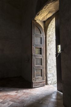 Old wooden door of the church in backlight